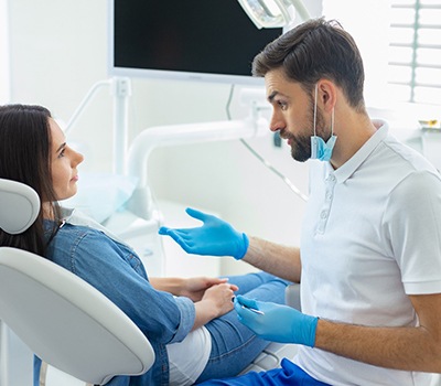 Dentist explaining cost of dental implants in Mayfield Heights