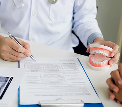 Implant dentist in Mayfield Heights discussing insurance with a patient