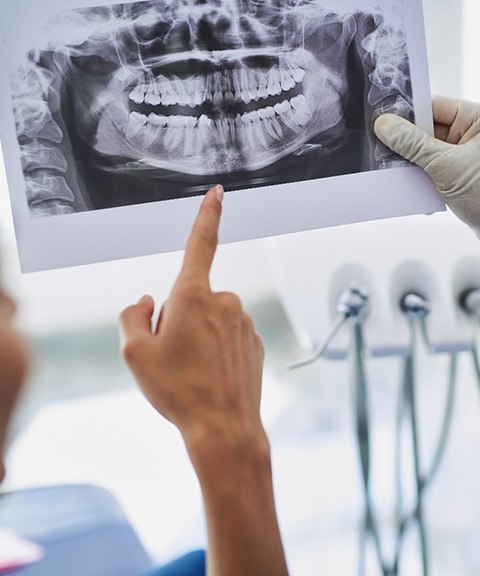 Dentist and patient discussing advanced dental implant procedures in Mayfield Heights