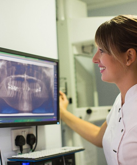 Dentist inspecting advanced dental implant technology in Mayfield Heights