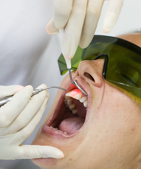 Patient receiving laser assisted new attachment procedure treatment