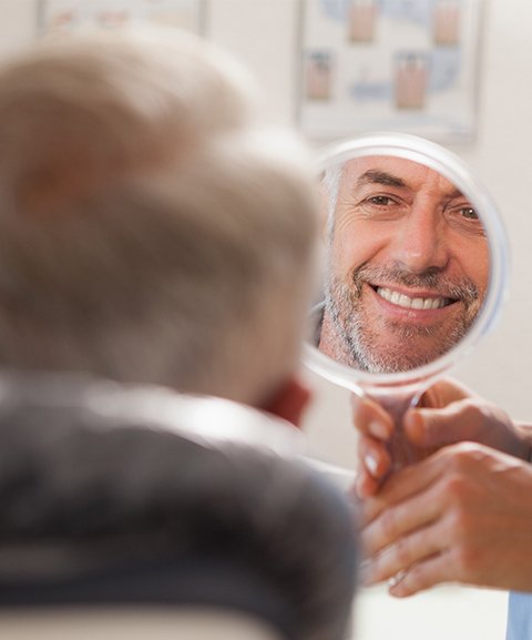 Man looking at smle after laser assisted new attachment procedure