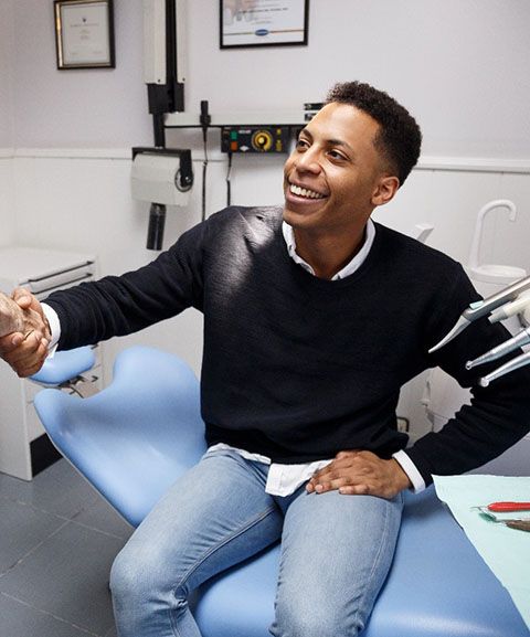 A male patient shaking hands with his dentist before discussing sedation dentistry options