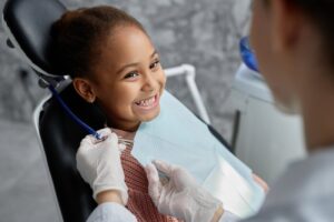 Child smiling while at the dentist